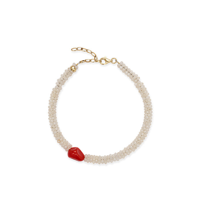 Ankle bracelet with white beads and a red accent