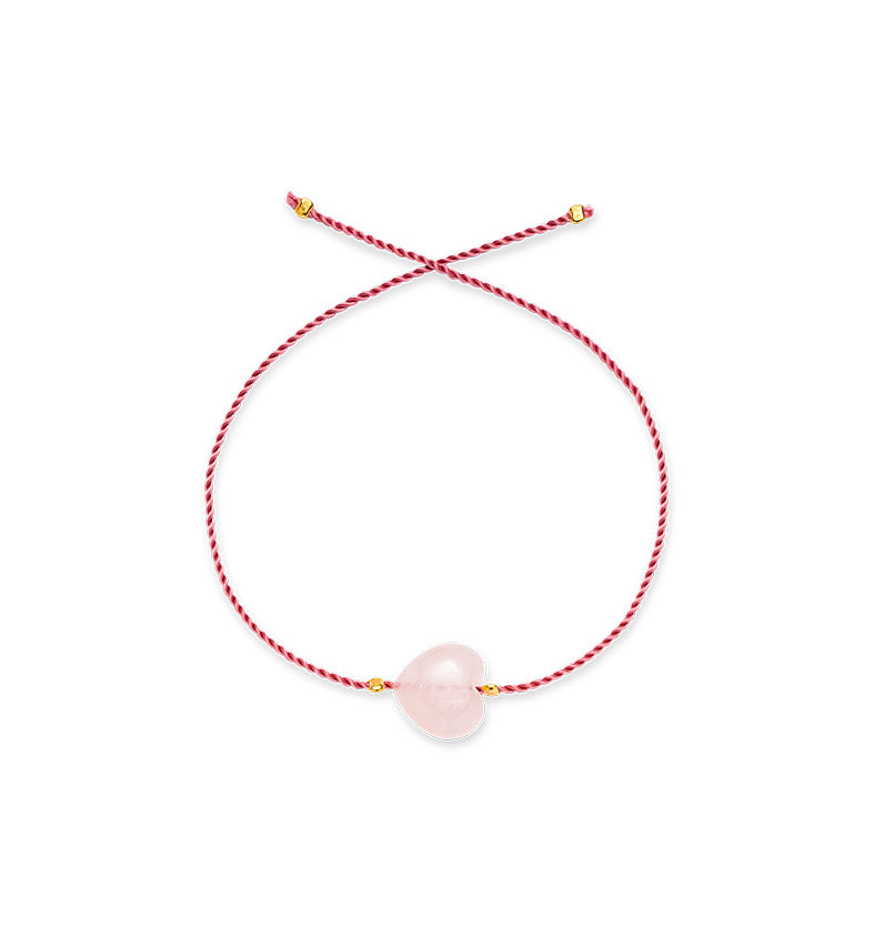  A bracelet on a pink string with a large pink heart 