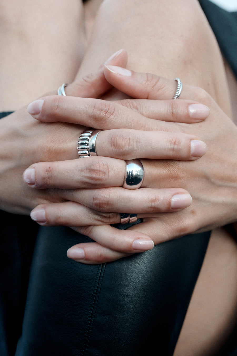 ESSENTIALS silver rings on the model’s hands