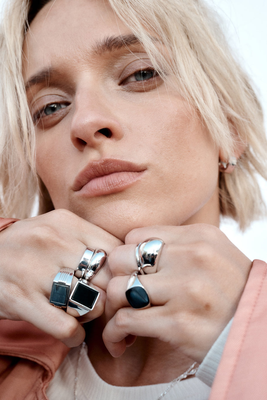ESSENTIALS silver rings styled with a pink shirt